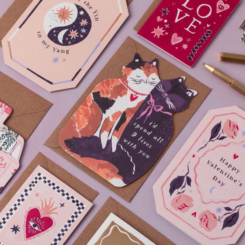 The perfect anniversary card or Valentines card for a cat lover, this uniquely shaped greeting card is cut into the shape of two snuggling cats. The adorable cat cards are blank on the inside, ready for a handwritten romantic message to be added