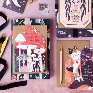 This mushroom birthday card is cut into the shape of mushrooms in a glittering night sky with mystical bugs and stars around. The perfect magical mushroom birthday card for a witch or whimsigoth.