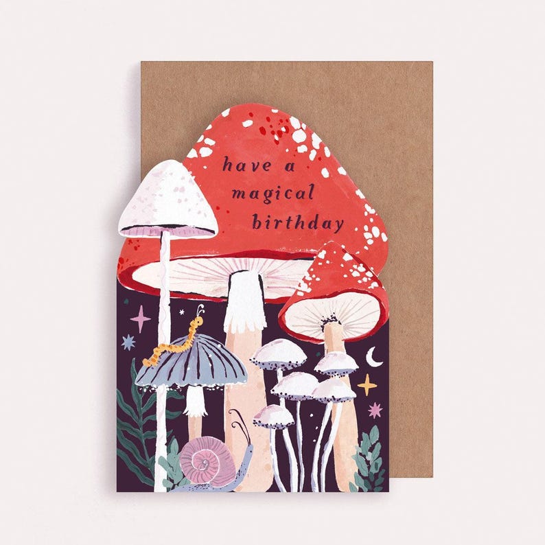 This mushroom birthday card is cut into the shape of mushrooms in a glittering night sky with mystical bugs and stars around. The perfect magical mushroom birthday card for a witch or whimsigoth.
