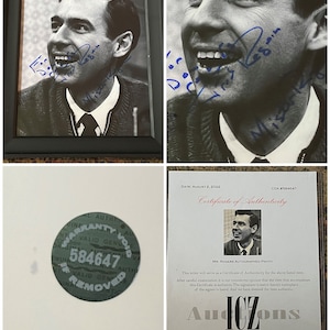 May include: A black and white photo of Fred Rogers, also known as Mr. Rogers, is framed in a black frame. The photo is signed in blue ink by Fred Rogers. A certificate of authenticity is included with the photo. The certificate is dated August 2, 2022, and has a COA number of 584647. The certificate is signed by Dave Norman.