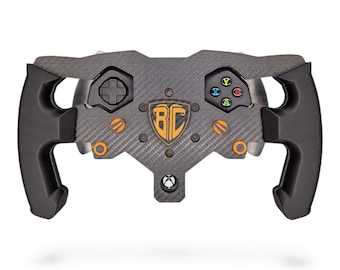 May include: A carbon fiber racing steering wheel controller featuring black ergonomic grips, a central shield emblem with the letters BC, a directional pad, and four colored action buttons labeled Y, X, B, and A. The device includes orange accents.