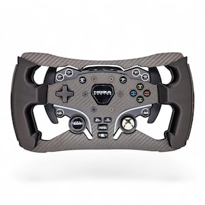 May include: A Moza Racing steering wheel controller featuring a carbon fibre textured frame, black ergonomic grips, and a central console with various buttons labelled LT, RT, S1, S2, N, P, LSB, RSB, Radio, and Home, alongside an Xbox logo button.