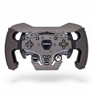 以下が含まれることがあります： 中央にMOZA RACINGのロゴが入ったカーボンファイバー製の黒いレーシングステアリングホイールコントローラー。十字キー、ラベル付きの各種ボタン、Xboxスタイルのボタン、人間工学に基づいたサイドグリップを備えており、ドライビングシミュレーションに使用されます。