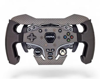 May include: A black carbon fiber racing steering wheel controller featuring the MOZA RACING logo in the center. The device includes a D-pad, various labeled buttons, an Xbox-style button, and ergonomic side grips for a simulated driving experience.