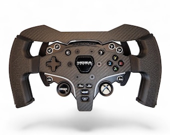 May include: A black carbon fiber racing steering wheel controller featuring the Moza Racing logo in the center. The device includes a directional pad, various labeled buttons, a central Xbox-style button, and textured ergonomic hand grips.