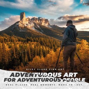 May include: A landscape photograph of a mountain with a flat top and snow-covered peaks. A person is seen with a camera on a tripod, taking a picture. The image includes text that reads "ADVENTUROUS ART FOR ADVENTUROUS PEOPLE."