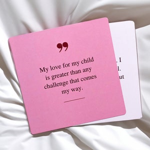 May include: Pink card with a quote about love for a child. The quote reads "My love for my child is greater than any challenge that comes my way."