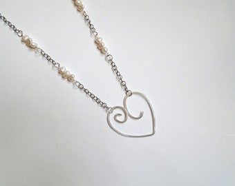 Necklace with silver plated hammered wire heart pendant, strung on chain with freshwater pearls