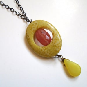 Beaded necklace, natural oval stone in yellow-green with faceted orange stone in center, antiqued gold chain