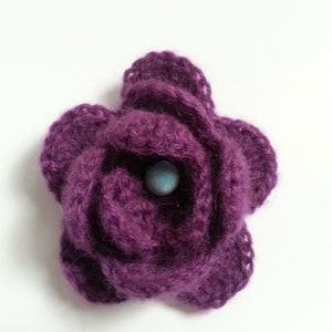 Crocheted flower pin, pinkish-purple fuzzy yarn, aqua bead center