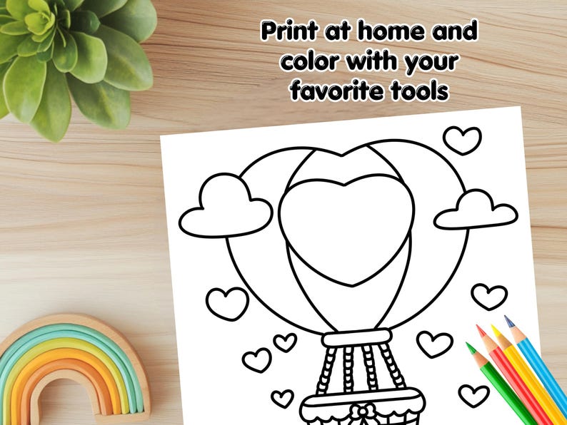 May include: A black and white coloring page featuring a hot air balloon shaped like a heart with clouds and hearts around it. The text "Print at home and color with your favorite tools" is at the top of the page.