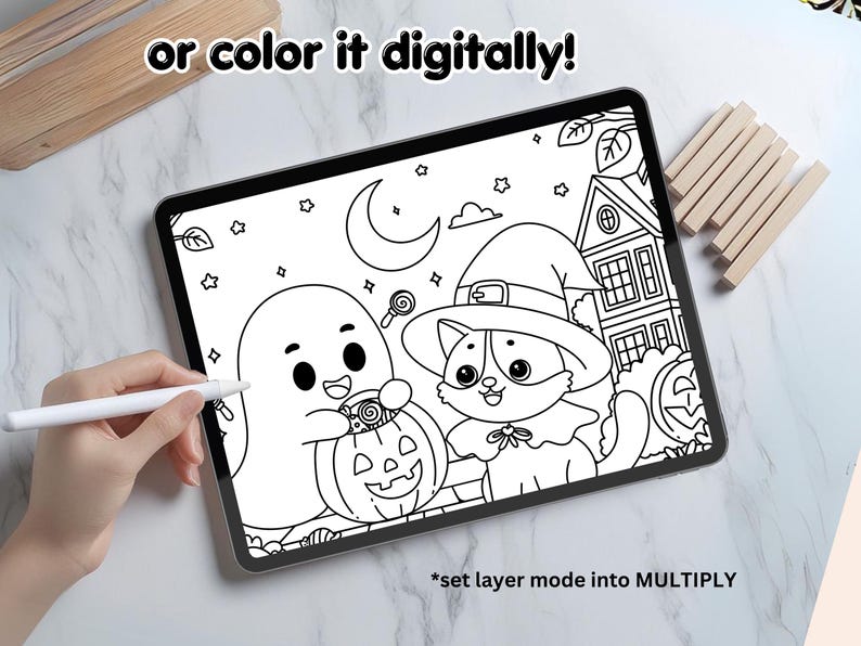 May include: A black and white printable coloring page featuring a ghost holding a jack-o-lantern, a cat wearing a witch hat, and a house with a candy cane. The text "or color it digitally!" is at the top of the page. The text "*set layer mode into MULTIPLY" is at the bottom of the page.