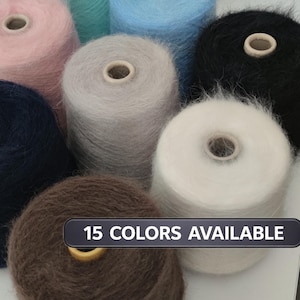 May include: A collection of yarn spools in various colors, including pink, blue, gray, and black. The spools are cylindrical with a central hole. Text on the image reads "15 COLORS AVAILABLE."