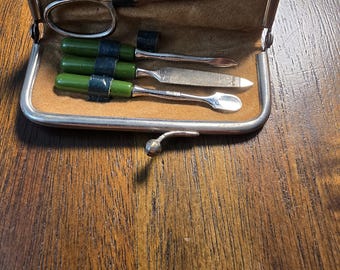 Discover the charm and craftsmanship of vintage German personal accessories with this complete pocket-sized manicure set, proudly marked Mad