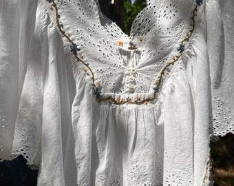 White eyelet, formerly Free People peasant top w/ delicate hand embroidery encircling yoke; Embroidered M-L sweet and simple prairie blouse.