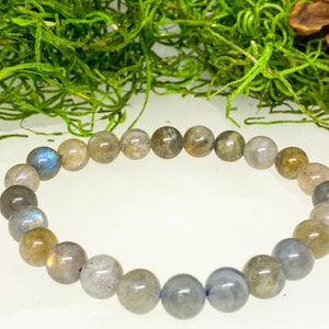 May include: A gray and blue labradorite gemstone bracelet with round beads.