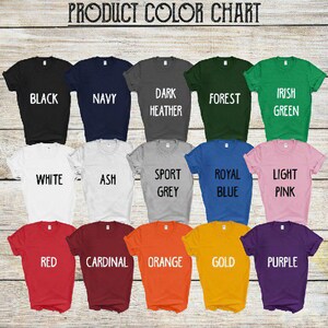 May include: Color chart showing 15 different t-shirt colors. The colors are: black, navy, dark heather, forest green, Irish green, white, ash, sport grey, royal blue, light pink, red, cardinal, orange, gold, and purple.
