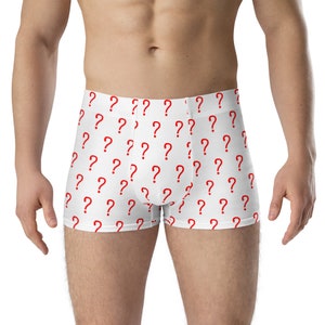 May include: White boxer shorts featuring a repeating pattern of red question marks. The underwear has a comfortable waistband and a classic boxer short cut. The question mark design adds a playful touch to the garment.