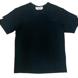 May include: Black crew neck t-shirt with short sleeves. The shirt has a small white tag near the neckline. The sleeves have a unique cut-out design. The shirt is made of a soft material.