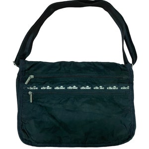 May include: Black messenger bag with a shoulder strap. The bag has multiple zipped compartments and the brand name "ellesse" printed in white across the front. The bag is made of a nylon-like material.