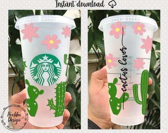 May include: A white reusable cup with a green cactus and pink flower design. The cup has a Starbucks logo and the text "cactus lover" written vertically on the side.