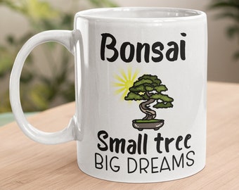 May include: White ceramic mug with a black and white illustration of a bonsai tree and the text "Bonsai Small tree BIG DREAMS".