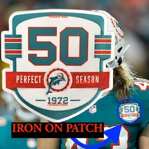 May include: Iron-on patch featuring a white shield with a teal number 50, the words "Perfect Season" and "1972" in red and black text. The patch has a dolphin logo and the words "NikkoSan" printed on it.