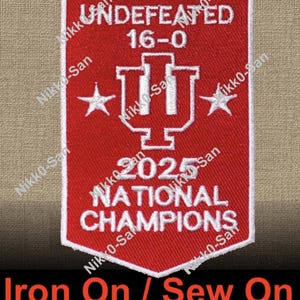 May include: Red and white embroidered patch with the text "UNDEFEATED 16-0" and "2025 NATIONAL CHAMPIONS". Features a white outline and a logo with two stars. The bottom of the patch reads "Iron On / Sew On".