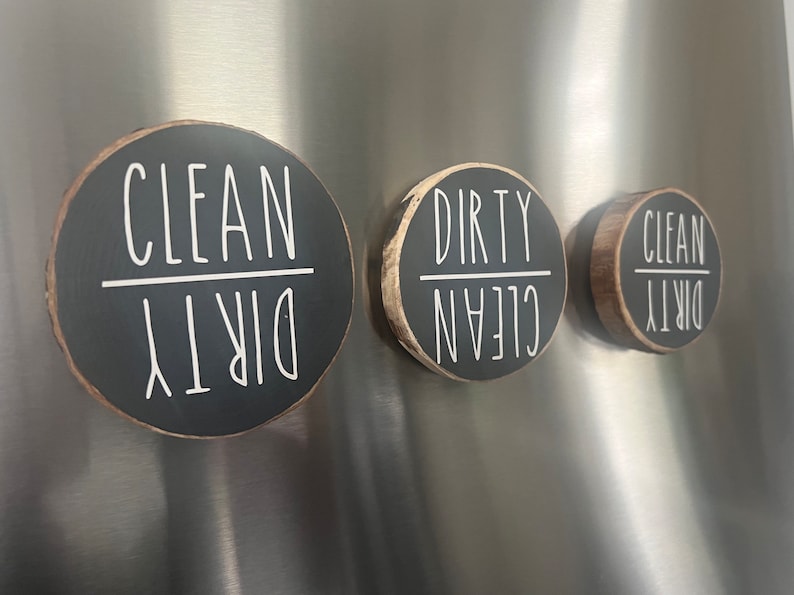 May include: Three round black wooden signs with white text. The signs say "Clean Dirty" and are flipped to show either "Clean" or "Dirty".