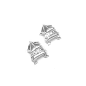 May include: A pair of silver earrings shaped like sailboats.