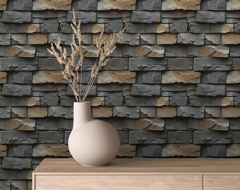 May include: A vase with dried flowers sits on a wooden shelf in front of a wall covered in faux stone wallpaper. The wallpaper has a dark gray and brown color scheme.