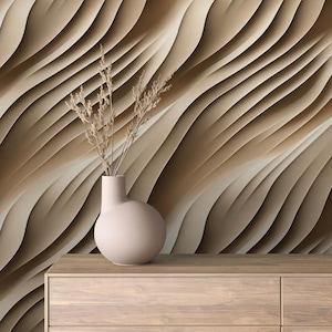 May include: A light brown vase with a rounded body sits on a wooden dresser in front of a wall with a 3D abstract pattern of wavy lines in shades of brown.