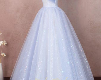 May include: A light blue off-the-shoulder ball gown with a tulle bodice and a sparkly tulle skirt. The dress has a fitted bodice and a full skirt.