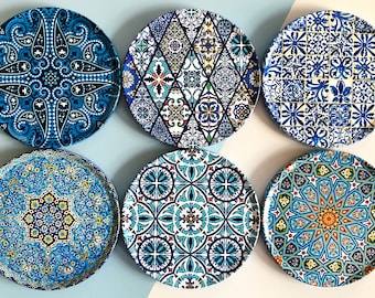 May include: Six decorative ceramic plates with blue and white geometric patterns. The plates feature intricate designs inspired by traditional Moroccan and Turkish tilework.