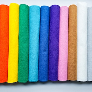 May include: A collection of 12 rolls of felt fabric in various colours, including red, orange, yellow, green, blue, purple, pink, brown, white, grey, and black.