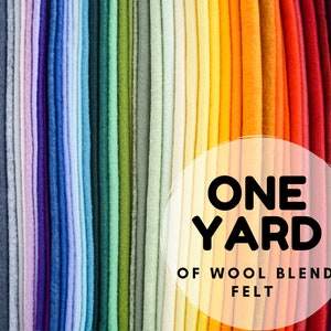 May include: A variety of colours of wool blend felt, each rolled up and stacked on top of each other. The text "ONE YARD OF WOOL BLEND FELT" is in a white circle in the centre of the image.