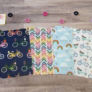 May include: Four different patterned paper dividers with a bicycle or scooter design. The dividers are blue, pink, light blue, and white with a variety of patterns including chevron, hearts, rainbows, and clouds.