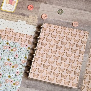 May include: A pink and brown butterfly patterned planner with a clear plastic cover and a set of dividers with floral and polka dot patterns.