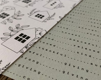 May include: A black and white illustration of a house with windows, surrounded by leaves and flowers. The image is printed on a white background. The image is placed on top of a green background with the words "giving", "kind", "honest", "peaceful", "relaxed", "strong", "thankful", "loved", "enough", "peace", "strong", "kind", "aut" printed in black.