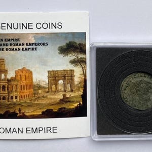 May include: A genuine Roman Empire coin in a protective case, next to a card with the text "GENUINE COINS" and a depiction of Roman ruins. The coin is circular and has a detailed design.