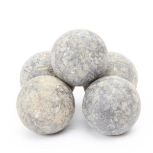 May include: Five gray stone spheres stacked in a pyramid shape. The spheres are rough and textured.