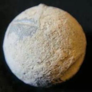 May include: A white ceramic sphere with a textured surface. The sphere has a light blue and white pattern on one side.