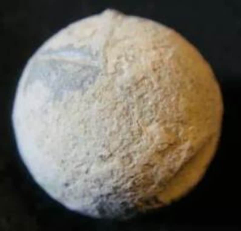 May include: A white ceramic sphere with a textured surface. The sphere has a light blue and white pattern on one side.
