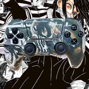 May include: A custom-designed video game controller featuring a manga-style graphic with a character in a white and black striped outfit. The controller has black buttons and a dark gray body, with a detailed illustration covering the surface.