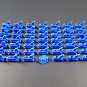 May include: A set of 40 blue plastic train engine pieces. The pieces are arranged in rows on a gray surface. There is a single blue plastic train wheel in the center of the image.