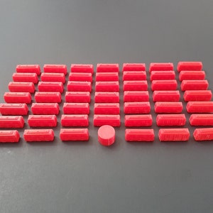 May include: A collection of 40 bright red rectangular game pieces and one red circular game piece.