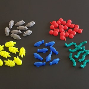 May include: A collection of colorful game pieces, including gray mice, yellow wheat stalks, blue fish, red berries, and green worms.