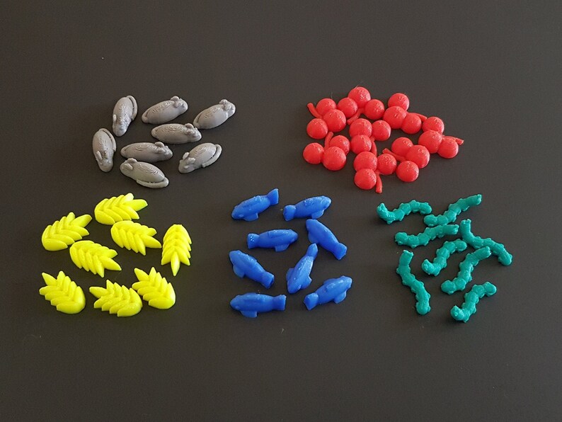 May include: A collection of colorful game pieces, including gray mice, yellow wheat stalks, blue fish, red berries, and green worms.