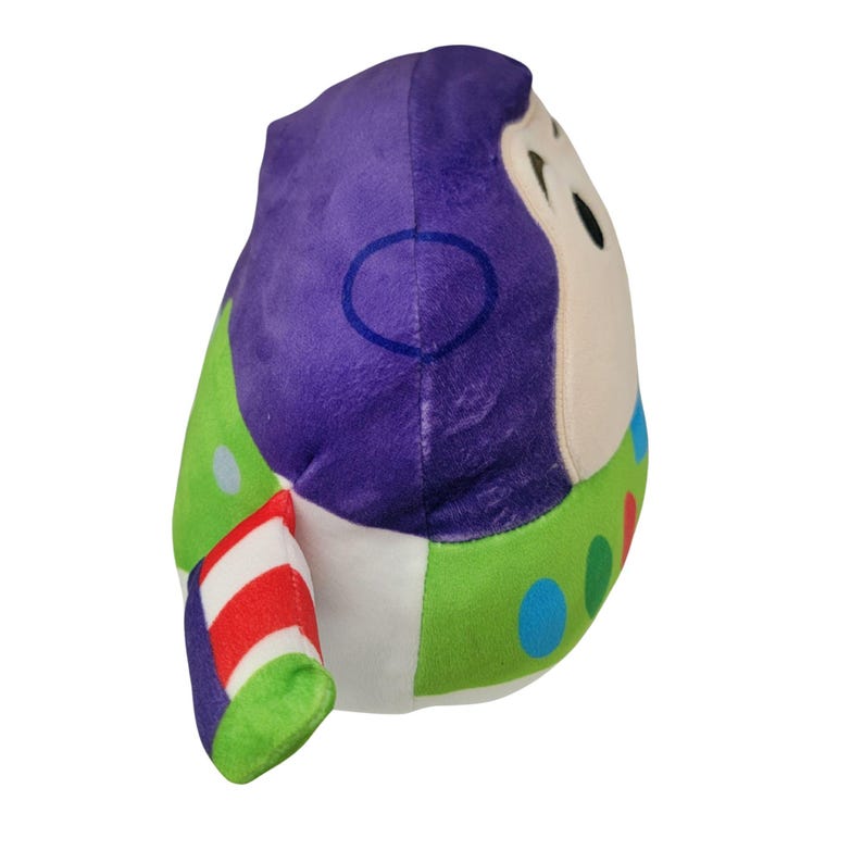 May include: A plush toy shaped like Buzz Lightyear from Toy Story. The toy features a purple head, green and white body, and a red and white striped arm. The toy has a friendly face and colorful details.