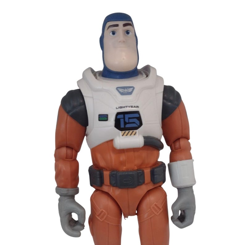 May include: A Buzz Lightyear action figure in a space suit. The figure has a blue head and a white and orange spacesuit with the number 15 on the chest. The figure is wearing gray gloves.